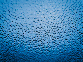 Fine raindrops on the car glass after waxing.