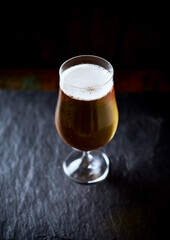 Glass of beer on dark background. Copy space.	