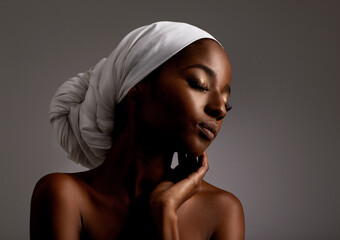 Beauty, cosmetics and black woman in dark studio with head scarf, skincare and pride in culture....