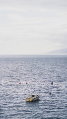 Fototapeta premium Lonely sailing boat in the coast of Rijeka, Croatia, on a stormy day