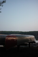 Sunrise on the shore of the lake with canoes.