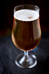 Glass of beer on dark background. Copy space.	