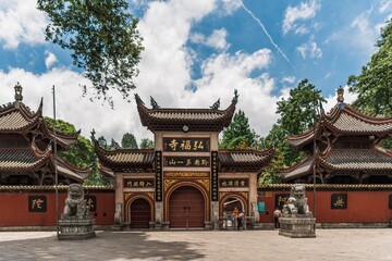 Gate of a traditional mansion in China with 2 stone lions on both sides