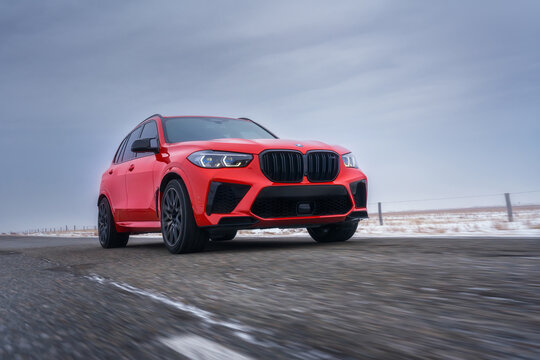 HELSINKI, FINLAND - MARCH 01, 2024: A red facelifted BMW X5 m Competition car is moving along the highway. A luxury SUV from a famous German brand.
