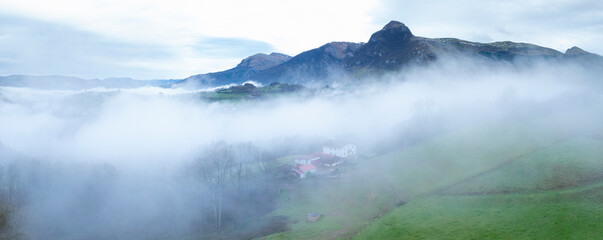Aerial drone view of the winter landscape around the town of Gainza and Amezqueta and the Txindoki Mountain. Aralar Mountain Range. Goierri region. Gipuzkoa. Basque Country. Spain. Europe