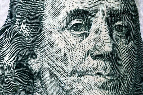 Benjamin Franklin's face on a hundred dollar bill. United States national currency banknote fragment. Benjamin Franklin portrait