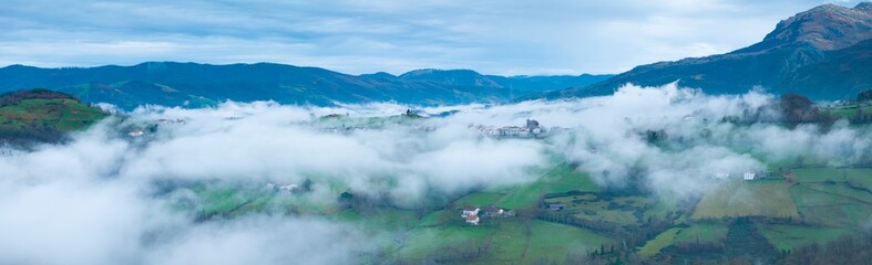 Aerial drone view of the winter landscape around the town of Gainza and Amezqueta and the Txindoki Mountain. Aralar Mountain Range. Goierri region. Gipuzkoa. Basque Country. Spain. Europe