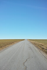 Blue sky, road trip and desert landscape for travel, holiday and natural scenery in countryside....
