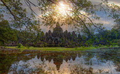 Ancient stone faces at sunset of Bayon temple, Angkor Wat, Siem reap, Cambodia.