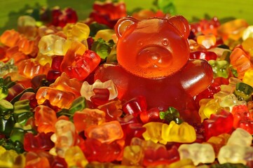 A teddy bear-shaped candy, sweet and colorful, evokes nostalgia with its charming design and sugary delight. - obrazy, fototapety, plakaty
