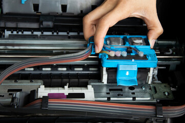 Technician repairing printer, fixing printer head