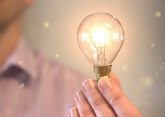 Person holding a light bulb