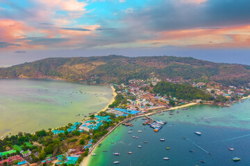 Travel vacation resorts aerial sunset sunrise above of the islands and settlements with hotel houses on the beaches of tropical resorts with boats and ships - obrazy, fototapety, plakaty
