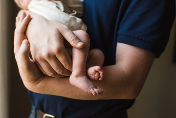 close up of a person holding baby