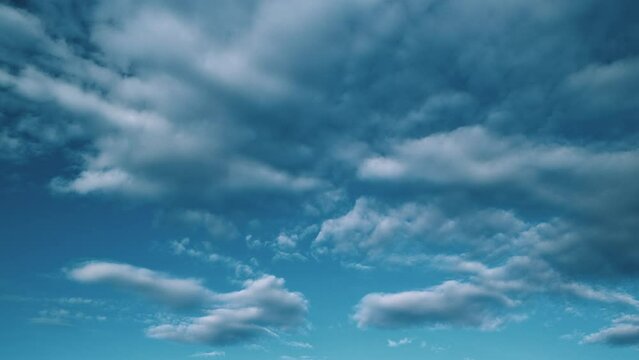 Tropical summer sunlight. White and blue cumulus and cirrocumulus on different layers clouds background. Tropical summer morning bright sunlight.
