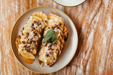 Toast with nut butter and fruit on a wooden table. Freshly toasted bread with banana and apple. Concept of delicious breakfasts and food flatlay