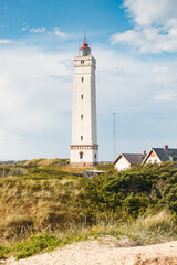 Fototapeta na wymiar Lighthouse in the sand dunes on the beach of Blavand, Jutland Denmark Europe