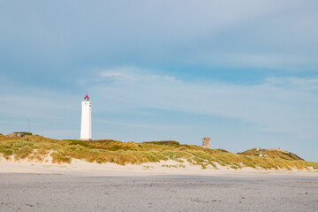 Lighthouse and bunker in the sand dunes on the beach of Blavand, Jutland Denmark Europe