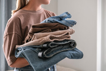 Spring cleaning,second hand,Fast fashion, the girl puts things in order in the closet. A bunch of...