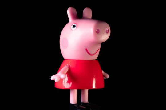 Peppa Pig in the red dress on a black background