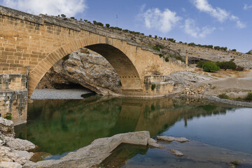 Fototapeta premium 2nd century AD Severan roman bridge on the Cendere River with the columns of the Roman Emperor Septimus Severus and the Empress Julia Domna, Turkey