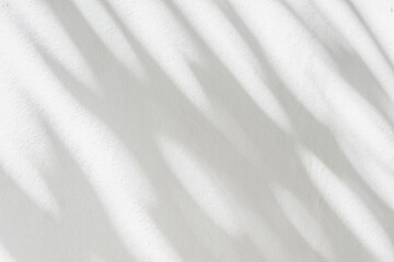 Light and shadow of leaf abstract grey background. Natural shadows and sunshine diagonal refraction on white concrete wall texture. Shadow overlay effect for foliage mockup, banner graphic layout