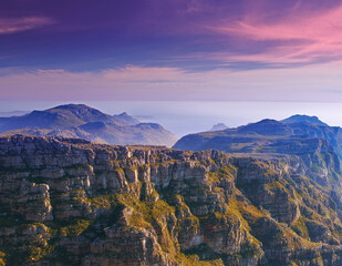 Mountain, clouds and sunset sky with color on horizon, natural landscape and cliff at travel location. Nature, hill and sustainable environment with earth, peace and destination at tropical island