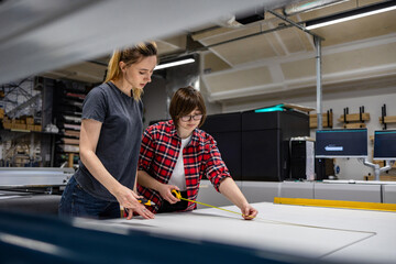 Professional female employees working in a printing house