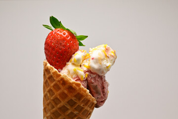 Close-up shot of ice cream cone with strawberry