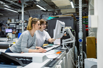 Professional female employees working in a printing house - obrazy, fototapety, plakaty