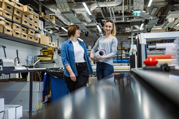Professional female employees working in a printing house