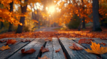 Naklejka na ściany i meble Wooden table with autumn leaves on bokeh background