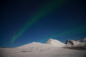 Shooting star amidst the Northern Lights (aurora borealis) in northern Norway