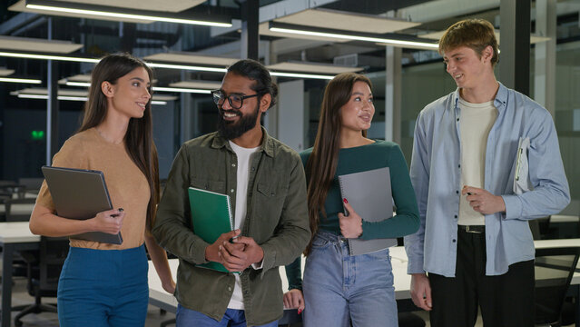 Happy young corporate employees business team diverse multiracial students office workers colleagues men women male female talking together in modern class creative girls guys studying in university