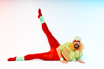 Vibrant Drag Queen in 80s Sportswear Practicing Stretching Exercises in a Studio Setting