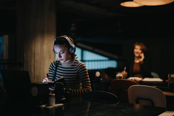 Late night collaboration of young executives ensures business success through persistence and...