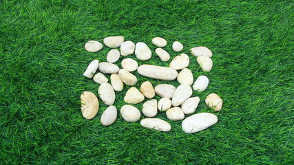 Naklejka premium Natural stone with texture, green grass, background