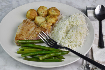 tuna steak served with scallops , rice and green beans,