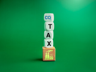 Carbon tax. Smoke factory icon on wood cube blocks stack with text, CO2 and TAX on white blocks...