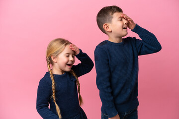 Little caucasian brothers isolated on pink background has realized something and intending the...