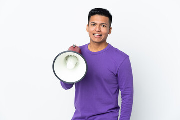 Young Ecuadorian man isolated on white background holding a megaphone and with surprise expression