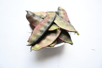 Fototapeta premium Lablab purpureus vegetable. It&nbsp;is a species of&nbsp;bean&nbsp;in the family&nbsp;Fabaceae. Its other names lablab bean,&nbsp;bonavist bean pea,&nbsp;dolichos bean,&nbsp;seim,&nbsp;lablab,&nbsp;Egyptian kidney bean,&nbsp;Indian bean. 