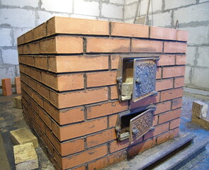 construction of brick ovens. brick stove for sauna. heating stone stove.