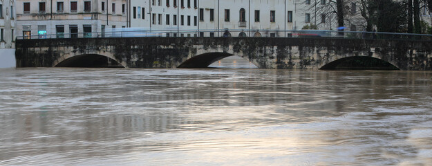 Naklejka premium almost submerged arches of the Old Bridge called Ponte Pusterla in the city of Vicenza in northern Italy during the flood with the Bacchiglione river