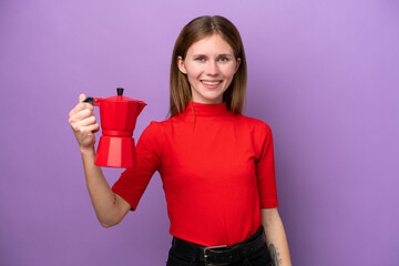 Young English woman holding coffee pot isolated on purple background with happy expression