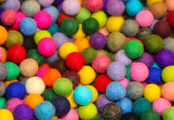 Fototapeta na wymiar background of colorful balls made of boiled wool on sale in the hobby and pastime shop