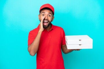 Pizza delivery Brazilian man with work uniform picking up pizza boxes isolated on blue background...