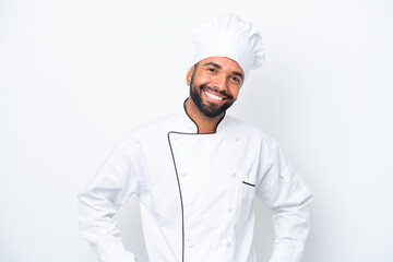 Young Brazilian chef man isolated on white background posing with arms at hip and smiling