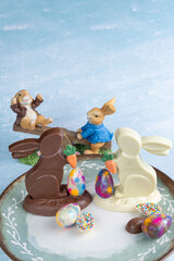 Milk and white chocolate bunnies next to small chocolate eggs_2.