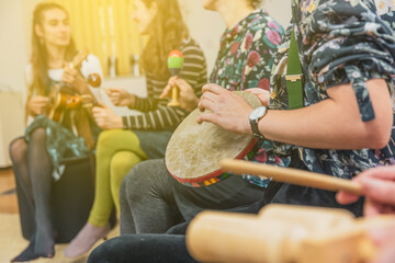 Group of people playing on different kinds of musical instruments during music therapy